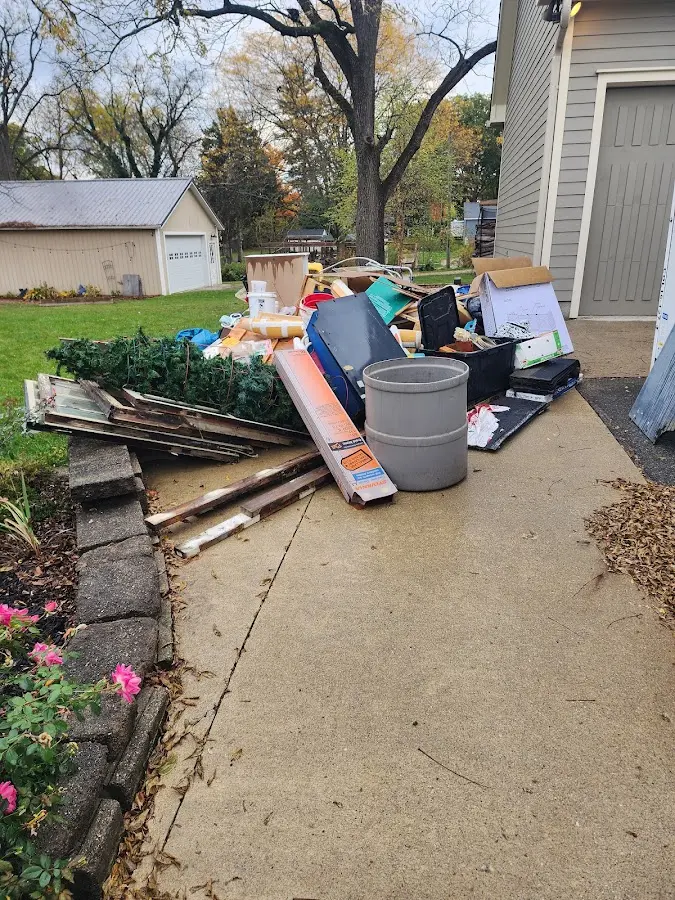 Dumpster being loaded with debris for Commercial Dumpster Rental in Berwyn Heights